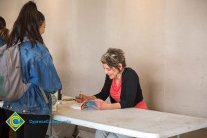 Ellen Forney signing a book.