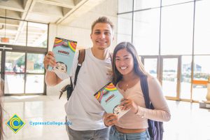 Two students holding Ellen Forney book, "Marbles: Mania, Depression, Michelangelo, and Me: A Graphic Memoir Paperback".