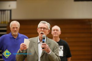 Former coach Don Johnson speaks as Swen Nater and Mark Eaton watch from behind.