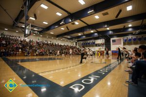 Fans in the stands and referees running the court at the Legends of Hoops night.