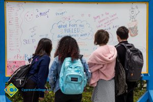 A whiteboard records student thoughts at a stress-relieving event.