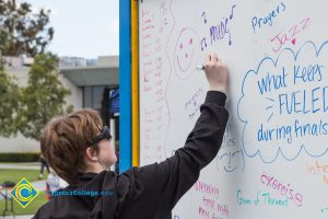 A whiteboard records student thoughts at a stress-relieving event.