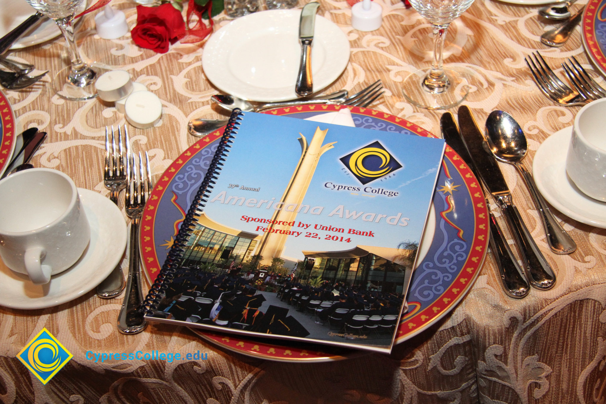 Table setting with red, white and blue plate, and the Americana Awards Program.