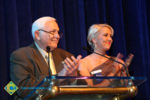 A man and a woman applauding.