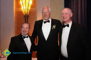 Former NBA players Mark Eaton and Swen Nater standing with a man in a black suit and tie at the 39th Annual Americana Awards.