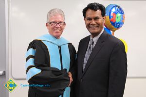 President Bob Simpson shaking hands with Peter Mathews.