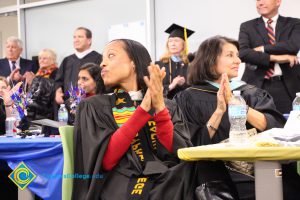 Staff applauding during commencement reception.
