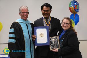 President Bob Simpson, Peter Mathews and Jolena Grande holding an award.