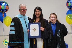 President Bob Simpson and Jolena Grande with a graduate.