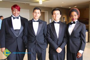 Two young men and two young women in black suits.