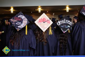 Three decorated caps during commencement.