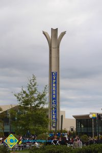 The campanile lit up with a Cypress College banner.