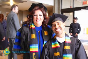 Dr. Therese Mosqueda-Ponce with graduate Obed Silva in cap and gown.