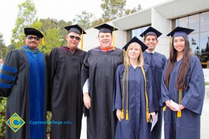 Graduates in staff in caps and gowns.