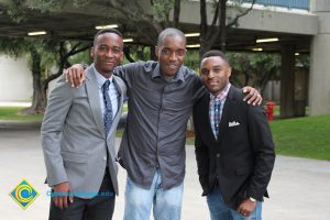 Three young men enjoying the 48th Commencement.