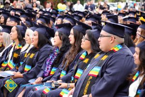 Graduates in their cap and gown at commencement.