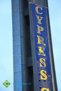 The campanile lit up with a Cypress College banner.