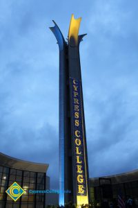 The campanile lit up with a Cypress College banner.