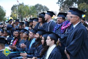 Graduates in their cap and gown at commencement.