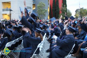 Graduates in their cap and gown at commencement.