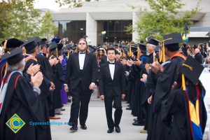 Two young men in black tuxedos during 48th Commencement processional.