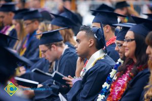 Graduates in their cap and gown at commencement.