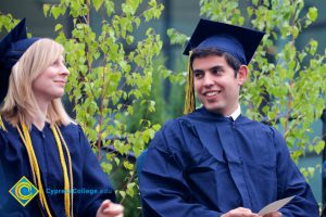 A blonde young lady and a young man smiling during the 48th Commencement.