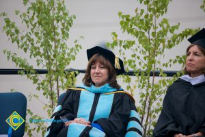 A smiling Dr. Barbara Dunsheath in cap and gown during 48th Commencement.