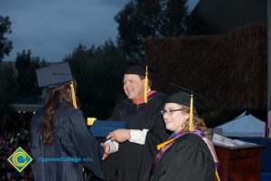 Student receives degree during the 48th Commencement.