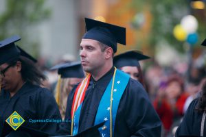 A young man in his cap and gown during the 48th Commencement.