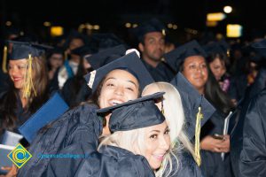 Smiling students enjoying the 48th Commencement.