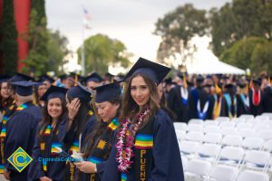 Graduates in their cap and gown at commencement.