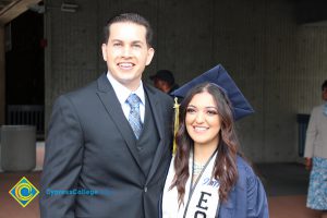 Alan Reza with an EOPS graduate in her cap and gown.