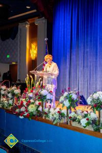 President, JoAnna Schilling speaking on stage.