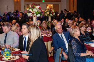 Audience at 44th Annual American Awards sitting at their tables listening to presenters.