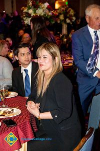 Woman with blond hair and bangs and young man in a suite and blue tie.