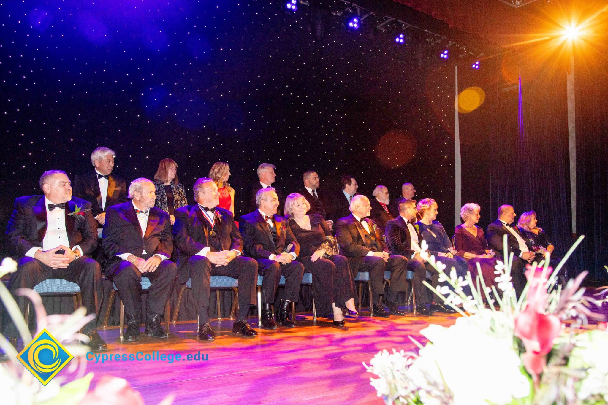 A large group of men and women on stage at the 44th Annual Americana Awards.