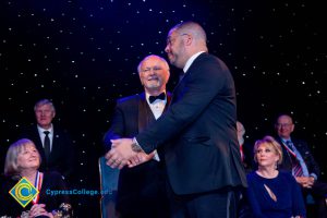 Men in suits shaking hands.