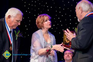 President JoAnna Schilling extends her hand to an award recipient.