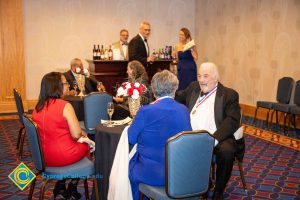 Table with men and women talking.