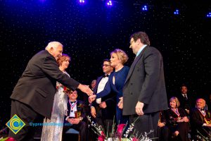 Men and women on stage receiving awards.