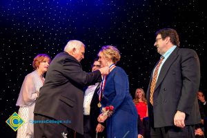 Men and women on stage receiving awards.