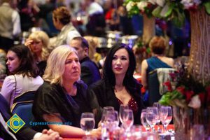 Two women sitting at a table at the 44th Annual Americana Awards.