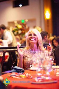 Woman with blond hair smiling.