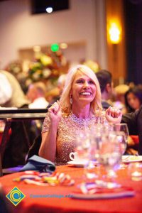 Woman with blond hair smiling.