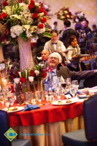 Man sitting at a table during 44th Annual Americana Awards.