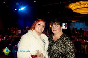 Lynette Young and a woman with red hair and white coat.