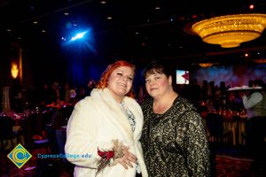 Lynette Young and a woman with red hair and white coat.