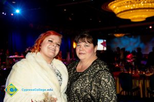 Lynette Young and a woman with red hair and white coat.