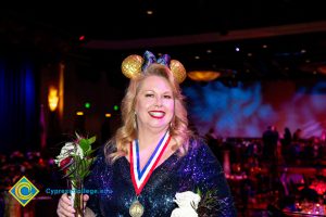 Woman wearing black and gold Mickey Mouse ears.